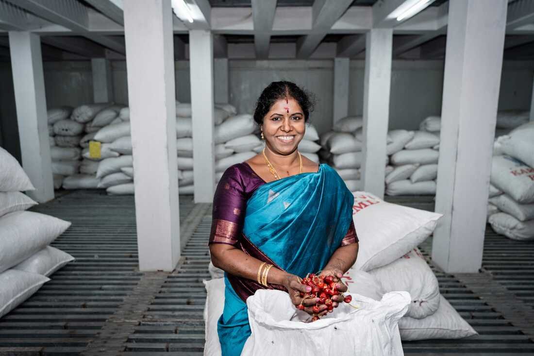 Sumathy Murugan, 45, a member of the Rural Women Development Foundation, holds mundu chiles in Ramanathapuram, Tamil Nadu. A government-run cold storage facility helps farmers store their crop and sell when prices rise, increasing earnings for many women.