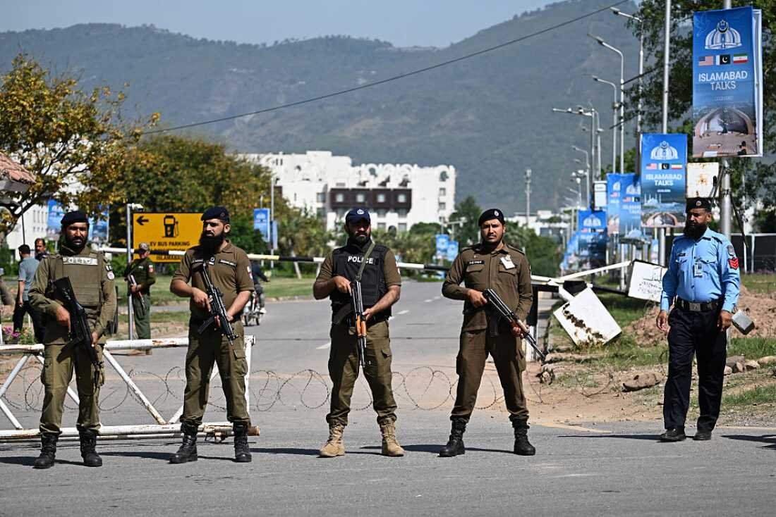 Security personnel stand guard at a security checkpost along a road temporarily closed near the Serena Hotel at the Red Zone area in Islamabad on April 20, 2026, ahead of anticipated US-Iran peace talks.