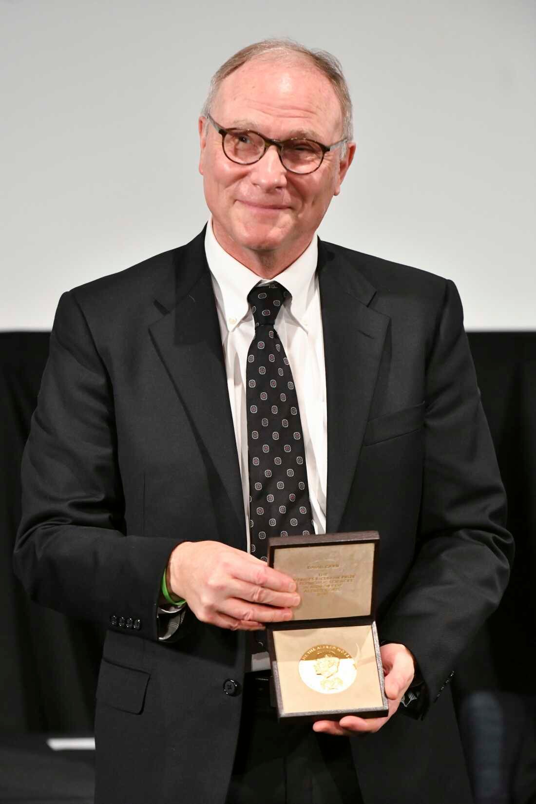 IRVINE, CALIFORNIA - DECEMBER 08: David Card poses with his medal after receiving Nobel Memorial Prize in Economic Sciences 'for work that challenged orthodoxy and dramatically shifted understanding of inequality and the social and economic forces that impact low-wage workers' on December 08, 2021 in Irvine, California. Due to the Covid-19 pandemic, the medal ceremony took place locally instead of the usual ceremony in Stockholm, Sweden. (Photo by Rodin Eckenroth/Getty Images)